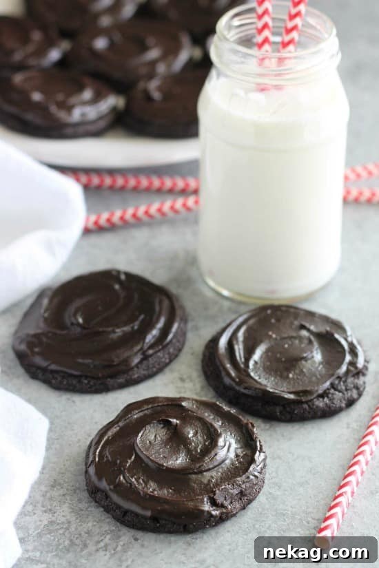 Fudgy dark chocolate sugar cookies are frosted with a creamy chocolate buttercream frosting. Inspired by Swig's Dirtball Cookie, these frosted chocolate sugar cookies are sure to be a new favorite!