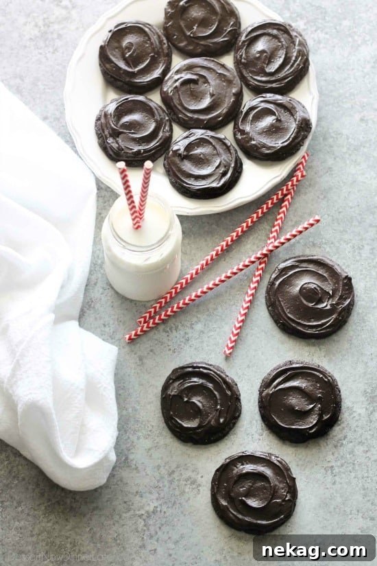 Fudgy dark chocolate sugar cookies are frosted with a creamy chocolate buttercream frosting. Inspired by Swig's Dirtball Cookie, these frosted chocolate sugar cookies are sure to be a new favorite!