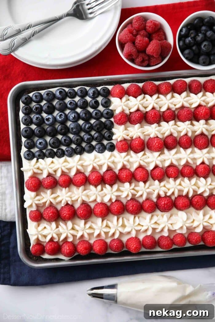 4th of July Fruit Pizza made with a brownie base and decorated with whipped cream cheese frosting, blueberries and raspberries for the stars and stripes.