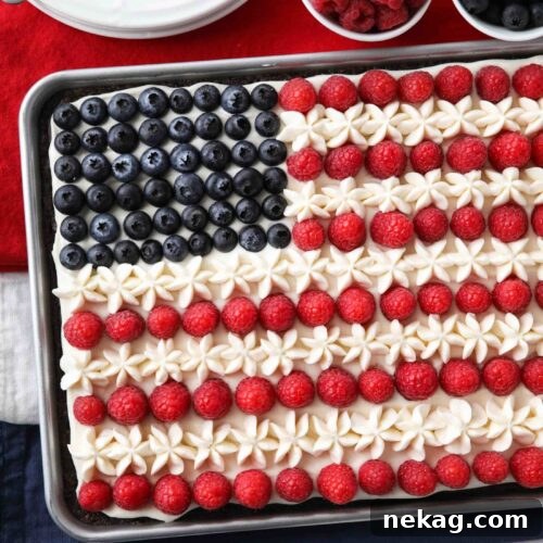 4th of July Fruit Pizza made with a brownie base and decorated with whipped cream cheese frosting, blueberries and raspberries for the stars and stripes.
