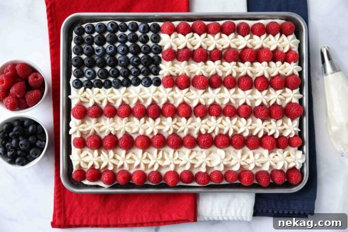 4th of July Fruit Pizza made with a brownie base and decorated with whipped cream cheese frosting, blueberries and raspberries for the stars and stripes.