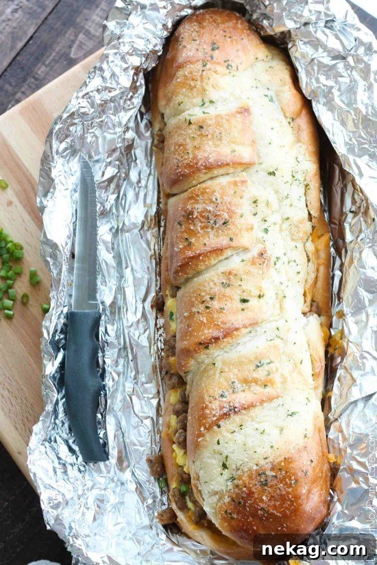 Breakfast-Stuffed French Bread: Savory Morning Sandwich Recipe 3 Sliced Breakfast Stuffed French Bread showing cheesy filling