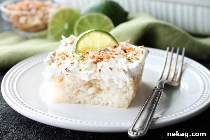 Slice of Coconut Lime Poke Cake showing moist texture.