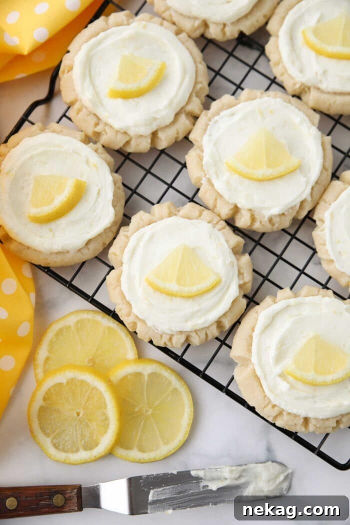 Top view of lemon sugar cookies with lemon frosting on a wire cooling rack.