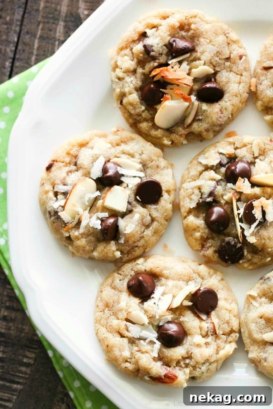 Almond Coconut Chocolate Chip Cookie Recipe for Chewy Treats 3 Almond Coconut Chocolate Chip Cookies are loaded with sliced almonds, shredded coconut, chocolate chips and flavored extracts for an Almond Joy inspired twist on the traditional chocolate chip cookie.