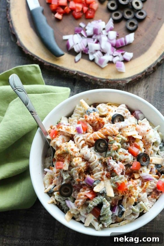 Bacon Ranch Pasta Salad is perfect for BBQ's and all your summer get togethers. It's loaded with pasta, bacon, cheese, olives, tomatoes, and onion - then tossed with a simple, creamy ranch dressing. 