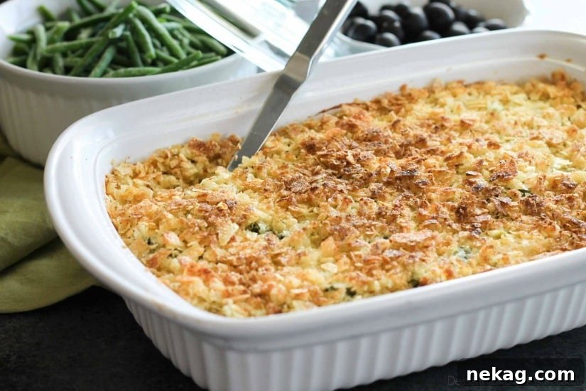 These funeral potatoes are creamy and cheesy, with sour cream, onions, extra spices, and a crunchy potato chip topping. Always a hit, this cheesy potato casserole will get gobbled up quick! Great for potlucks and holidays.