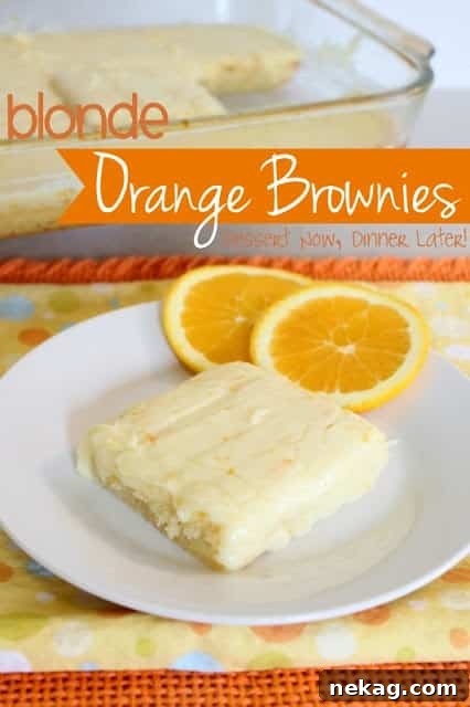 Orange brownie on a plate with orange cream cheese frosting.