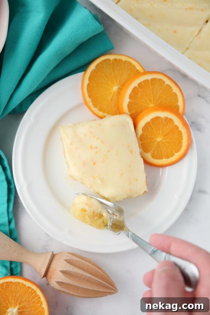 Fork full of orange brownies ready to be eaten.