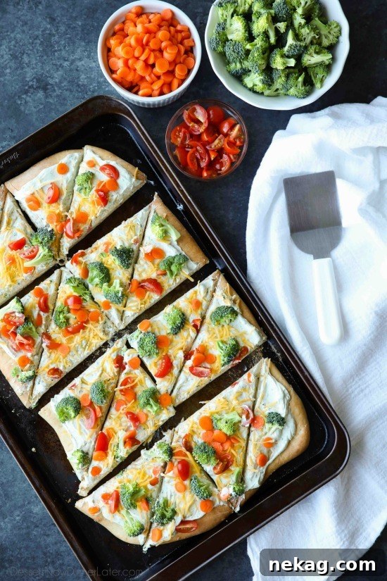 Slice of vegetable pizza with creamy ranch layer