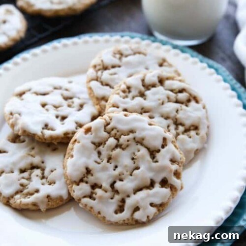 Old fashioned Iced Oatmeal Cookies are crisp on the outside, soft and chewy on the inside, with warm spices, and a light glaze on top. Perfect with a cold glass of milk!
