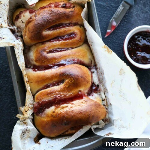 Intestines Bread is a fun halloween party food that makes you look twice. All it really is, is a sweet pull apart bread with cream cheese and raspberries.