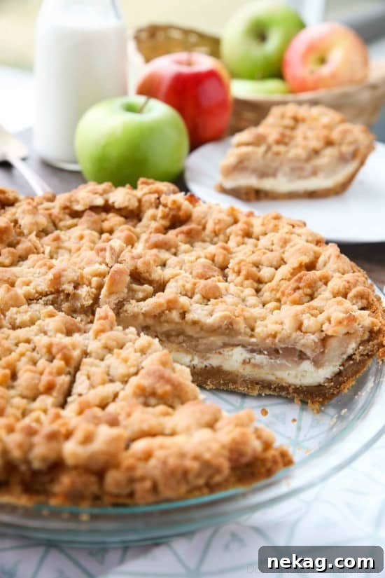Apple Streusel Cheesecake Pie (Recipe + How-To Video) 3 Apple Streusel Cheesecake Pie combines two dessert favorites with a graham cracker crust, creamy cheesecake layer, homemade apple pie filling, and crunchy streusel topping.