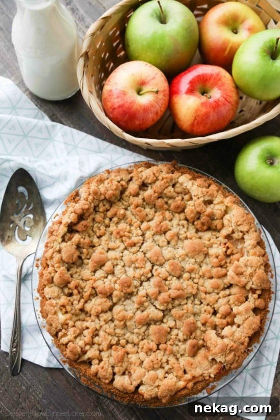 Apple Streusel Cheesecake Pie (Recipe + How-To Video) 4 Apple Streusel Cheesecake Pie combines two dessert favorites with a graham cracker crust, creamy cheesecake layer, homemade apple pie filling, and crunchy streusel topping.
