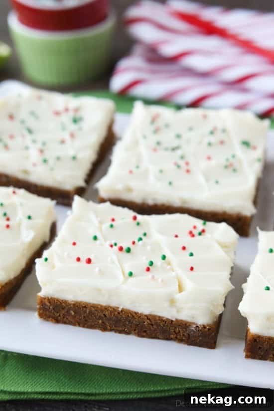 Gingerbread Cookie Bars have a soft and chewy, spiced molasses cookie base topped with cream cheese frosting.