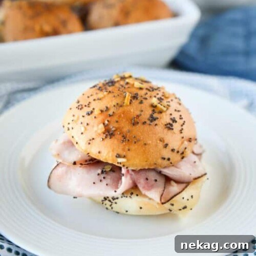 Ham and Cheese Sliders are baked in the oven with a buttery honey-mustard topping. Use leftover Christmas ham, or make them for dinner or game night. They're fast, easy, and feed a crowd!