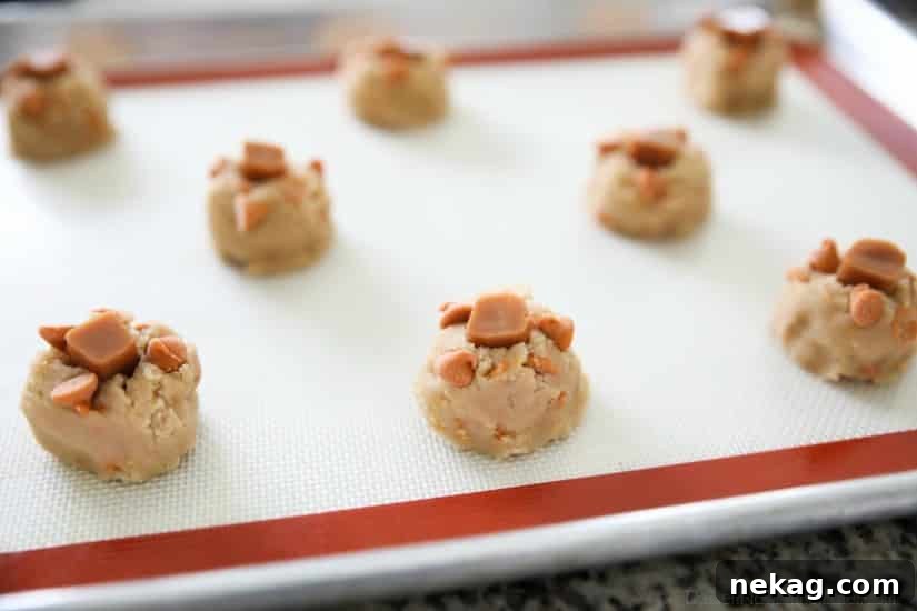 Salted Caramel Cookies are soft, chewy, and full of caramel, with just the right amount of salt. This sweet and salty dessert is one recipe you'll make again and again!