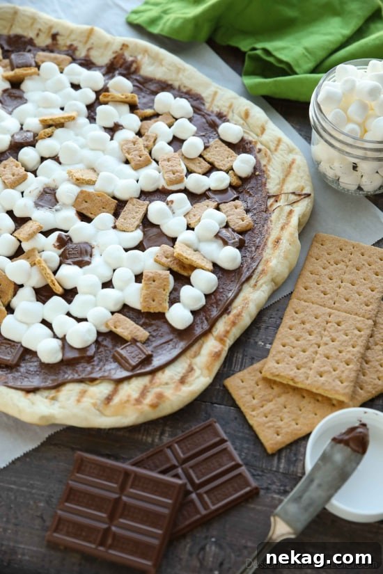 Make your dessert outside! This Grilled S'mores Pizza is an easy and delicious dessert with all the flavors of everyone's favorite campfire treat!