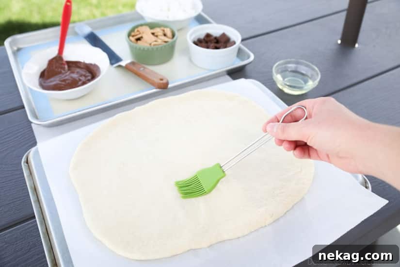 Make your dessert outside! This Grilled S'mores Pizza is an easy and delicious dessert with all the flavors of everyone's favorite campfire treat!