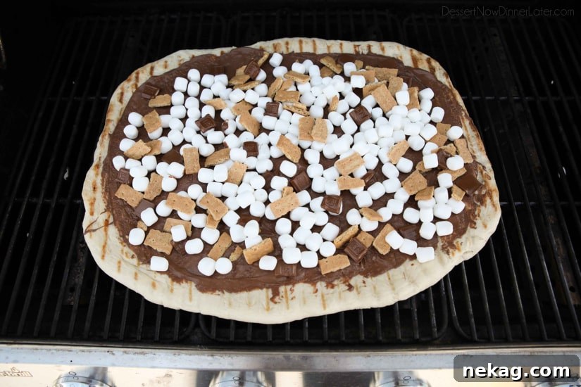Make your dessert outside! This Grilled S'mores Pizza is an easy and delicious dessert with all the flavors of everyone's favorite campfire treat!