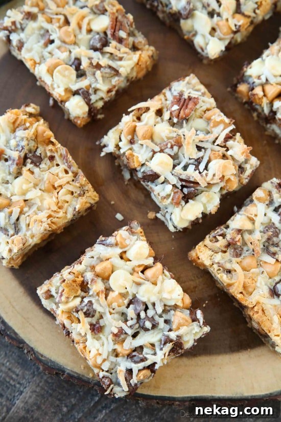 Chewy Seven-Layer Bars Recipe with Step-by-Step Video 3 Close-up of Seven Layer Bars showing layers of chips, nuts and coconut.