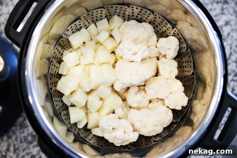 Lightened-up Creamy Cauliflower and Mashed Potatoes is a healthier side dish, with half cauliflower and half potatoes. Velvety smooth and creamy with less carbs and no milk, sour cream, or butter. Delicious enough for Thanksgiving or Christmas, yet simple enough for any dinner.