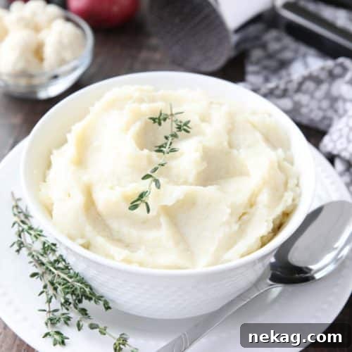 Lightened-up Creamy Cauliflower and Mashed Potatoes is a healthier side dish, with half cauliflower and half potatoes. Velvety smooth and creamy with less carbs and no milk, sour cream, or butter. Delicious enough for Thanksgiving or Christmas, yet simple enough for any dinner.