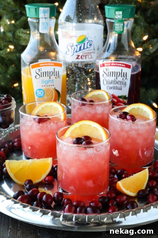 This non-alcoholic Cranberry Orange Mocktail is an easy and refreshing fruit punch drink for the holidays. It's fizzy, fruity, and only 3 ingredients!