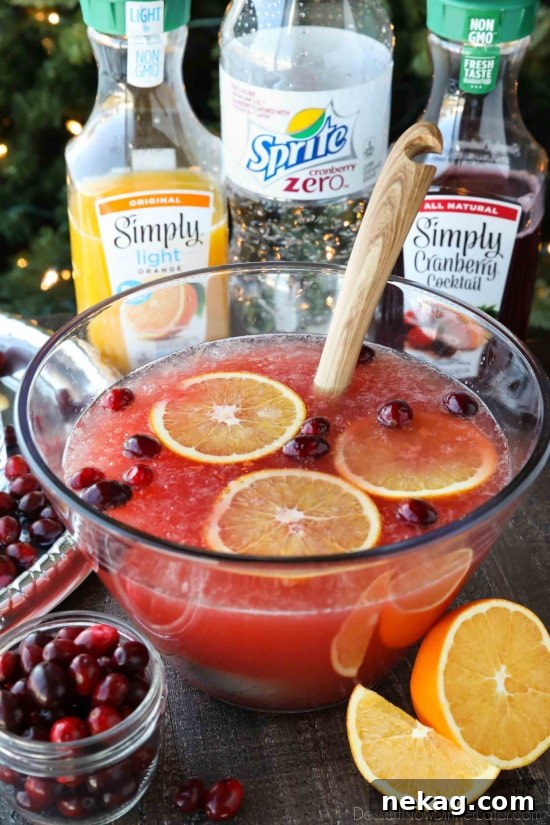 This non-alcoholic Cranberry Orange Mocktail is an easy and refreshing fruit punch drink for the holidays. It's fizzy, fruity, and only 3 ingredients!
