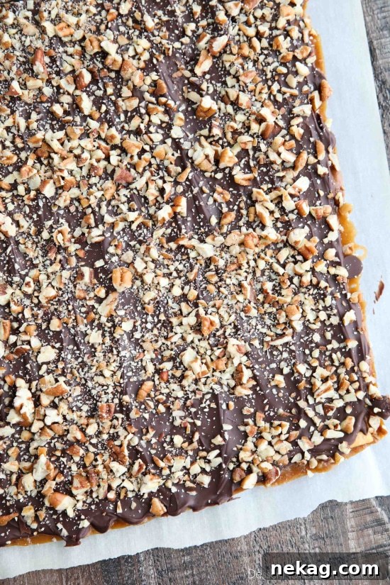 Cracker Toffee (aka Christmas Crack) is so easy to make and highly addictive! Saltine crackers are coated in a quick toffee layer and topped with chocolate and nuts.
