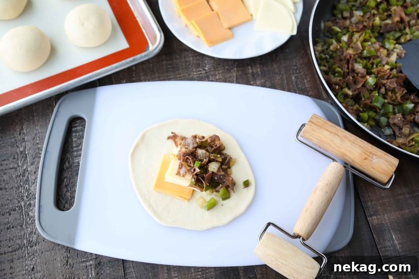 Philly Cheesesteak Bombs: Loaded Steak, Cheese & Onion Bites 7 Yeast dough rolled into a circle with cheese and meat on top.