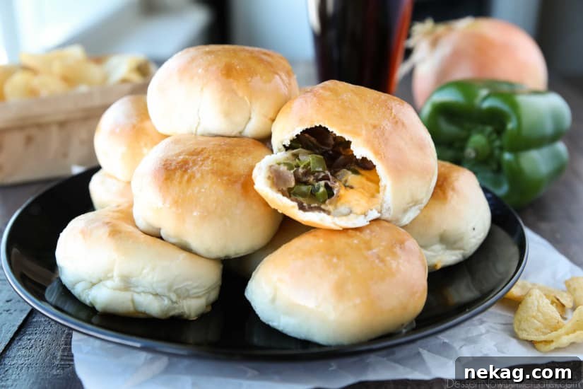 Philly Cheesesteak Bombs: Loaded Steak, Cheese & Onion Bites 10 Philly Cheesesteak Bombs roll ripped open with meat, veggies and cheese showing.