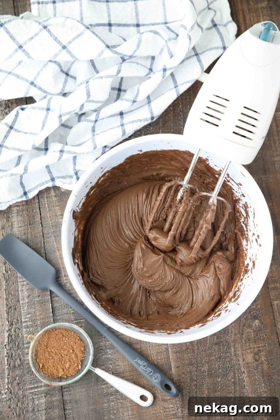 Silky Chocolate Cream Cheese Frosting Recipe (Video) 2 Chocolate cream cheese frosting made in bowl with hand mixer.