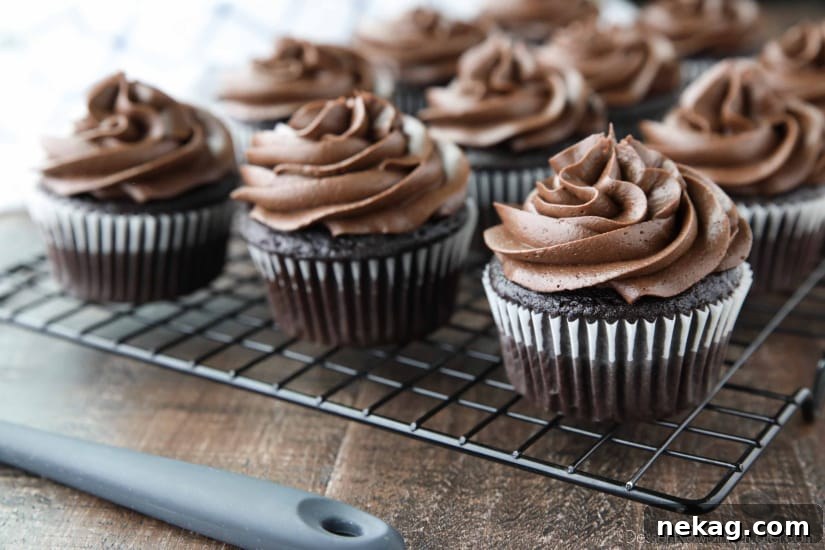 Silky Chocolate Cream Cheese Frosting Recipe (Video) 5 Chocolate Cream Cheese Frosting piped on top of chocolate cupcakes.