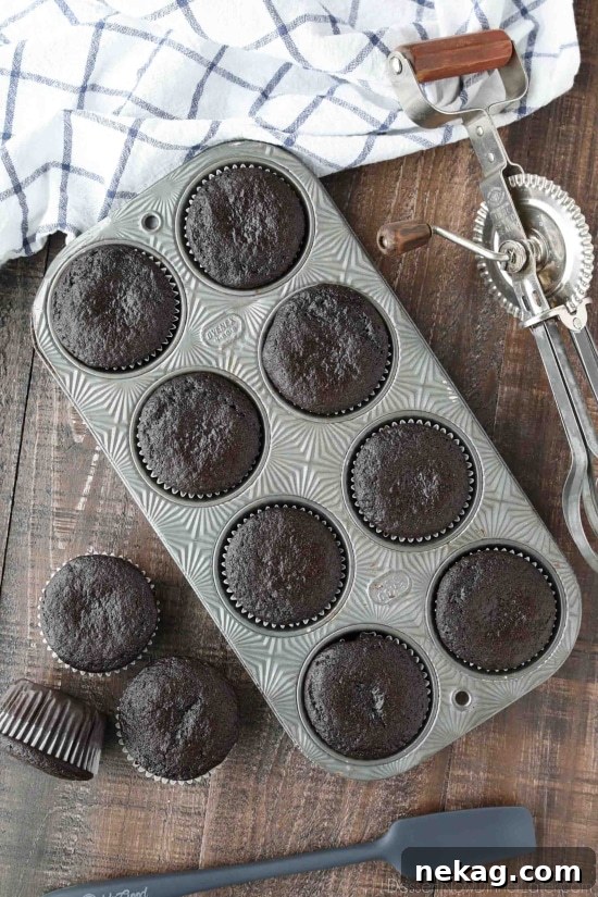 Chocolate Cupcakes Recipe with Step-by-Step Video Tutorial 3 Baked chocolate cupcakes in pan and on table.