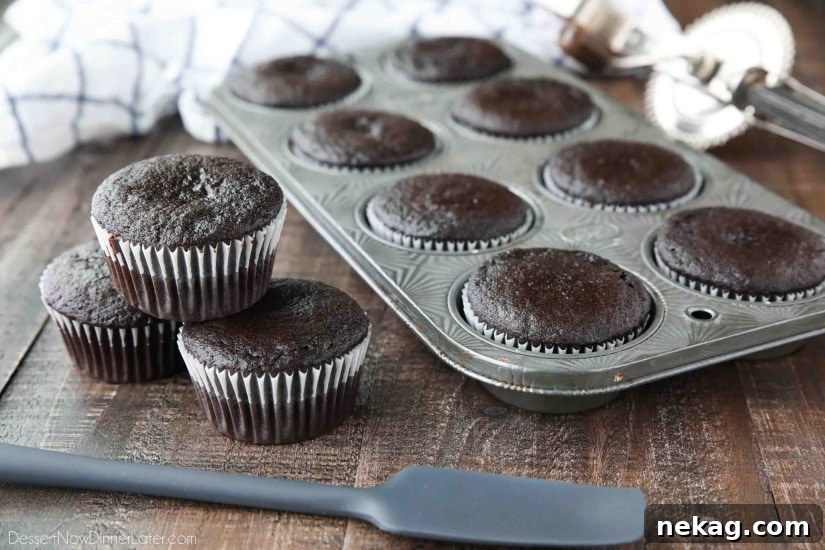 Chocolate Cupcakes Recipe with Step-by-Step Video Tutorial 5 Baked chocolate cupcakes in pan and on table.