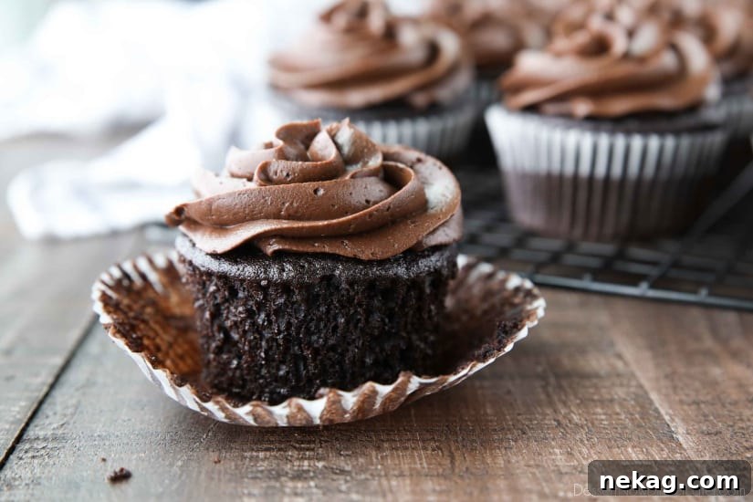 Chocolate Cupcakes Recipe with Step-by-Step Video Tutorial 6 Frosted chocolate cupcake with wrapper peeled down from sides.