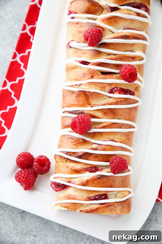 Raspberry Breakfast Braid - a quick raspberry sauce and cream cheese filling are stuffed inside this easy braided bread that's drizzled with a sweet and simple icing. A special breakfast or dessert for weekends or holidays with step-by-step pictures to help you make it.