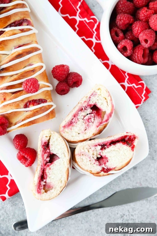 Raspberry Breakfast Braid - a quick raspberry sauce and cream cheese filling are stuffed inside this easy braided bread that's drizzled with a sweet and simple icing. A special breakfast or dessert for weekends or holidays with step-by-step pictures to help you make it.