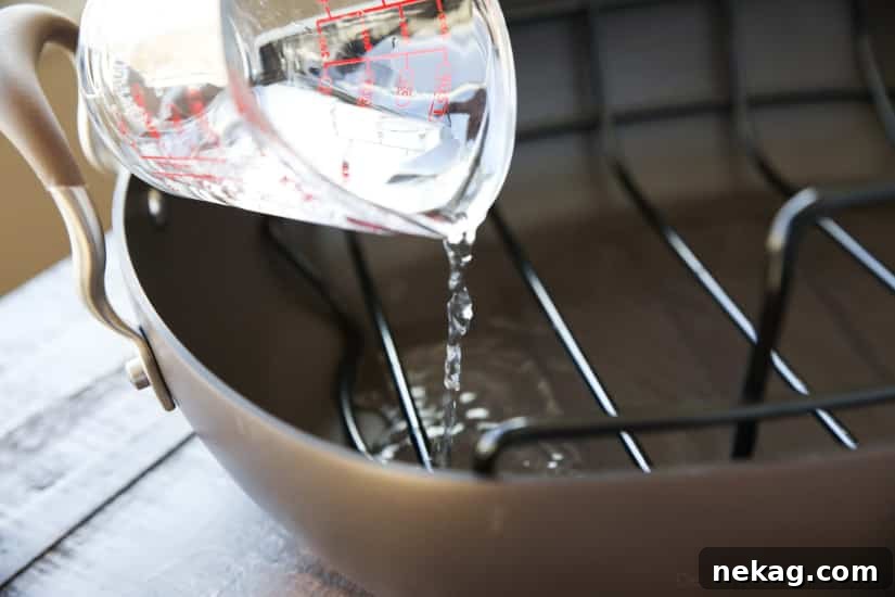 To cook ham, add water to the bottom of the roasting pan.
