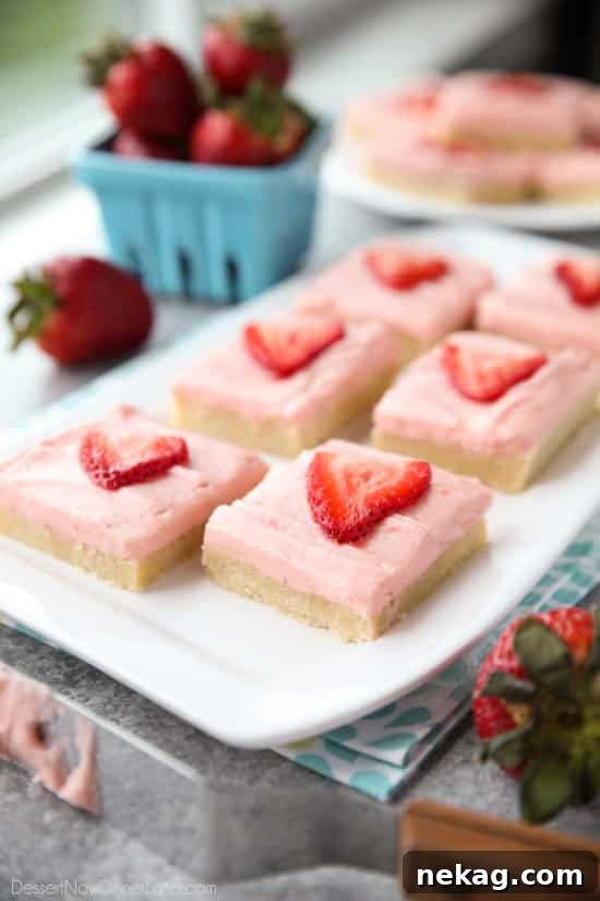 Strawberry Sugar Cookie Bars - soft, moist sugar cookie bars are topped with a natural strawberry frosting. Super easy to make and serves a crowd!