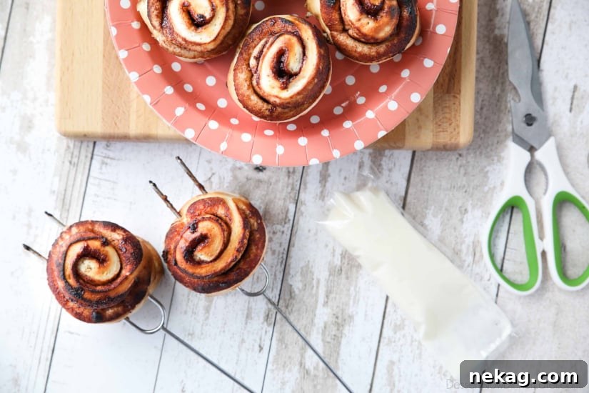 Campfire Cinnamon Rolls are cooked on a stick over a fire or grill. As easy as a can of biscuits, but with real yeast dough instead! The best cinnamon rolls you will ever have while camping!