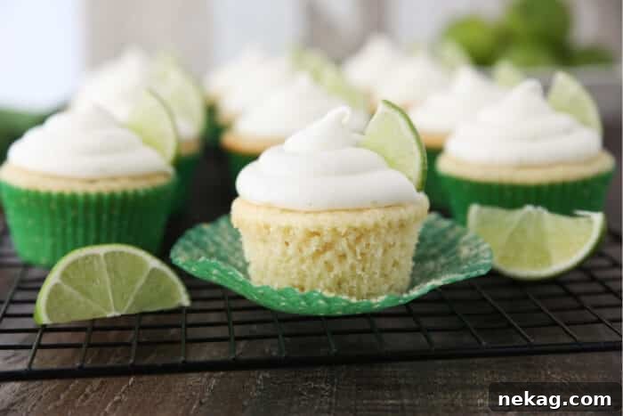 Key lime cupcake on wrapper that has been peeled down on the sides.