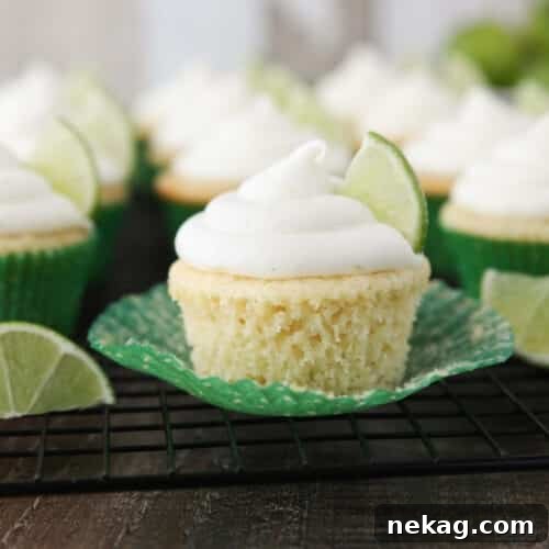 Key lime cupcake on wrapper that has been peeled down on the sides.