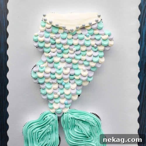 This Mermaid Tail Cupcake Cake is the perfect girls birthday cake, and this tutorial shows you exactly how to make it. Cupcakes pull apart for easy serving. (No cake to cut! Template included.)