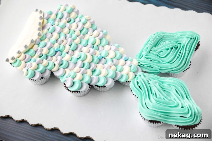 This Mermaid Tail Cupcake Cake is the perfect girls birthday cake, and this tutorial shows you exactly how to make it. Cupcakes pull apart for easy serving. (No cake to cut!)
