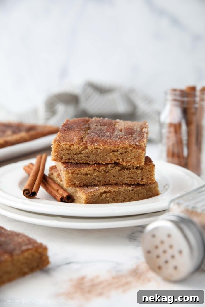 Chewy Cinnamon Bars with Brown Sugar Glaze 4 Side view of a stack of cinnamon bars on a plate.