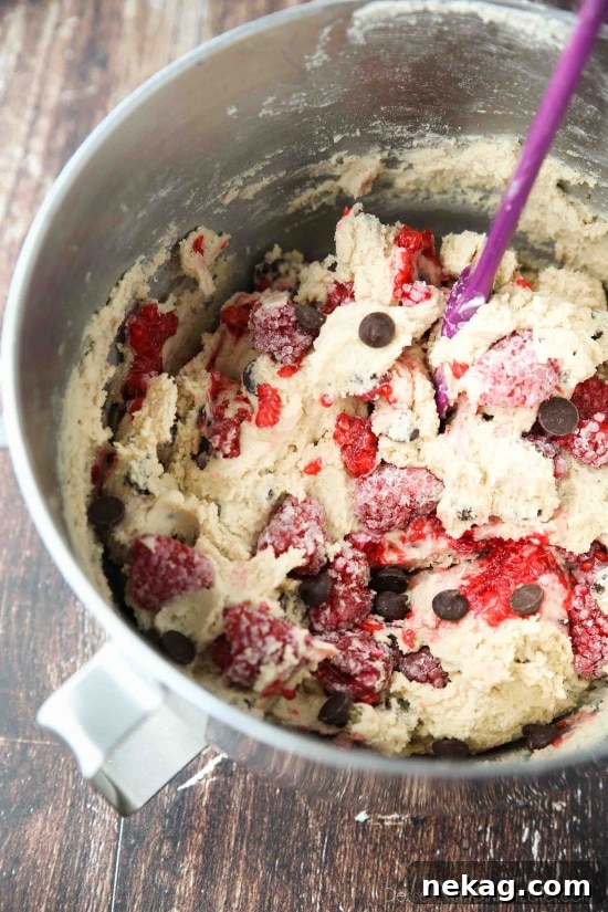 Raspberry Chocolate Chip Cookies Recipe with Video Tutorial 4 Raspberry Chocolate Chip Cookies takes your favorite chewy chocolate chip cookies to the next level with the addition of sweet and tangy fresh raspberries.