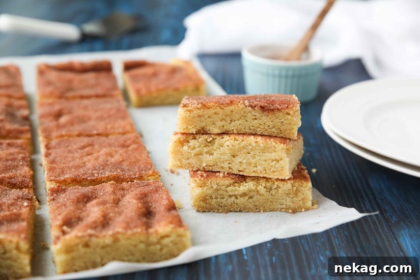 Snickerdoodle Bars transform classic snickerdoodle cookies into easy-to-make blondies. Thick, soft, buttery cookie bars are topped with plenty of cinnamon-sugar. These flavorful, melt-in-your-mouth dessert bars make enough to serve a crowd. Perfect for potlucks, picnics, and parties.