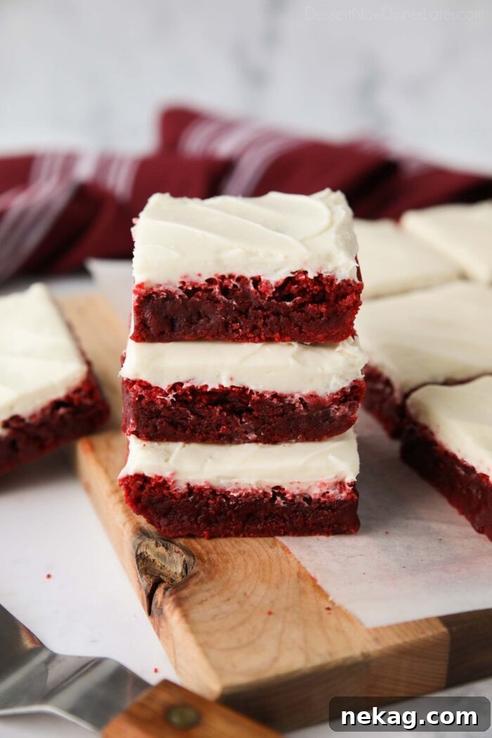 Decadent Red Velvet Brownie Recipe with Cream Cheese Swirl 2 Stack of three Red Velvet Brownies with cream cheese frosting.